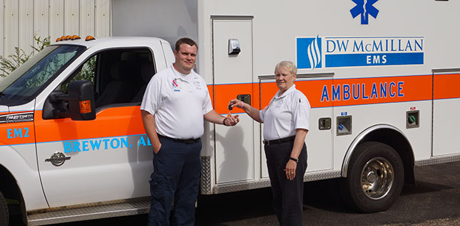 Justin Cole, Director of D.W. McMillan EMS standing next to a female EMT in front of an ambulance.