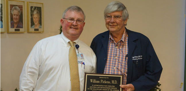 Dr. William Pickens, M.D. receiving a certificate for retiring