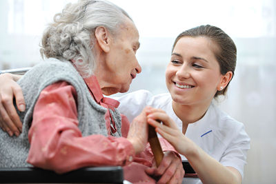 Picture of a female Nurse helping a female elderly patient.