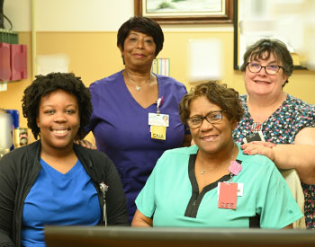 Four smiling female Nurses.