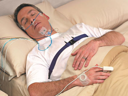 Sleep Center MakeoverPicture of a middle-aged man lying down in bed hooked up to cords for a sleep study